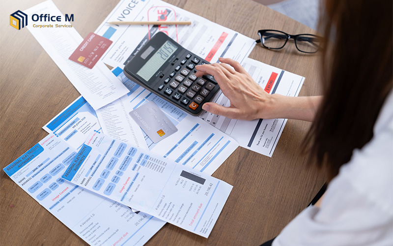 Woman calculating bills for SME financial foundation setup.