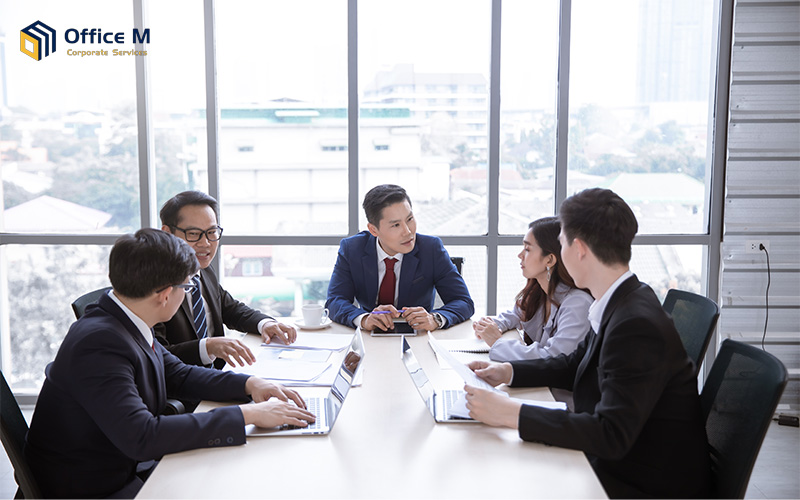 A diverse team of business professionals holding a formal meeting in a boardroom