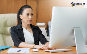 A corporate manager working on a computer