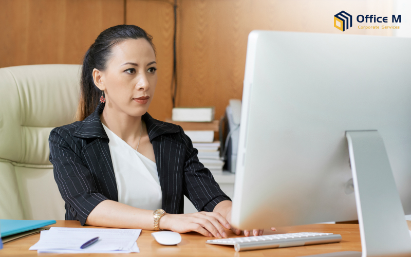A corporate manager working on a computer