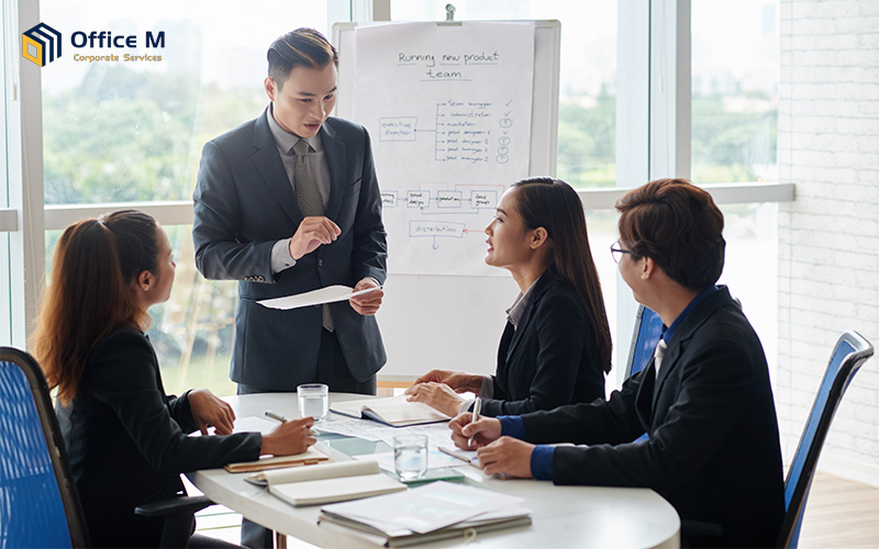 Diverse professional team at a small company in Singapore collaborating during an office meeting