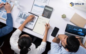 Professionals discussing marketing and financial data at a meeting for Office M.