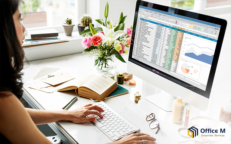 Woman managing multiple revenue streams in a spreadsheet.