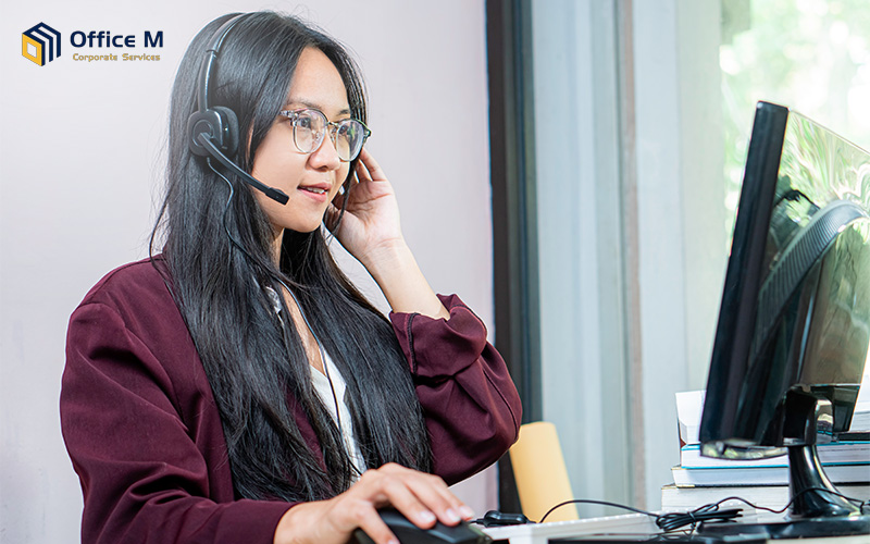 Corporate secretary providing client support with a headset.