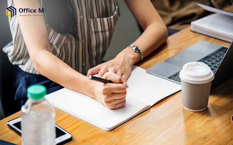 Corporate secretary preparing company documents and board meeting minutes.