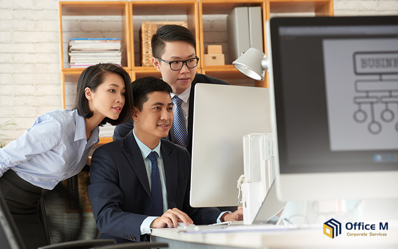 Office M consultants assisting a client with business setup.